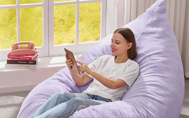 Lilac foam bean bag chair with a tablet propped up