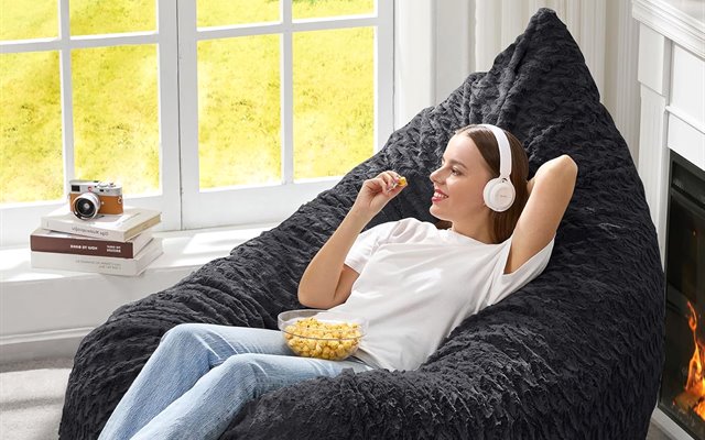 Black bean bag chair in a fireside corner
