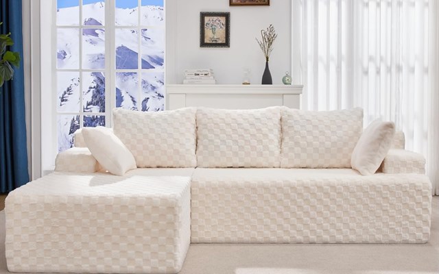 Cream checkered sectional sofa in front of a snowy window