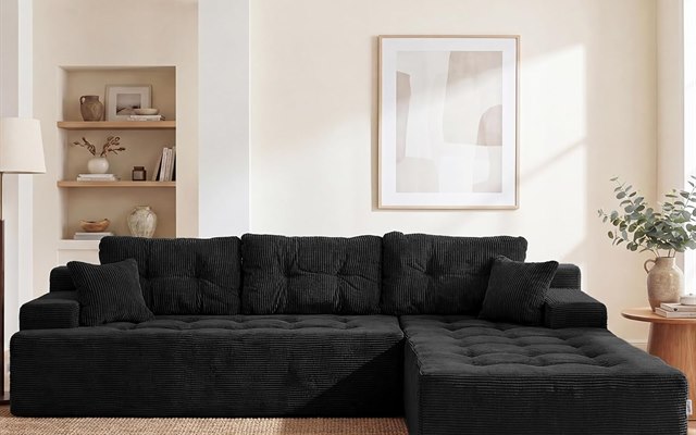 Black corduroy sectional sofa on a jute rug